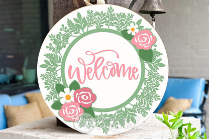 Digital SVG file for a floral welcome round door hanger, instant download laser cut design for DIY porch décor. This layered SVG features greenery, flowers, and a script welcome word designed for round signs. Use this digital file with laser machines to create your own custom door hanger or seasonal sign. SVG digital file only, no physical product included. Perfect for DIY sign making, farmhouse décor, and laser cut projects.