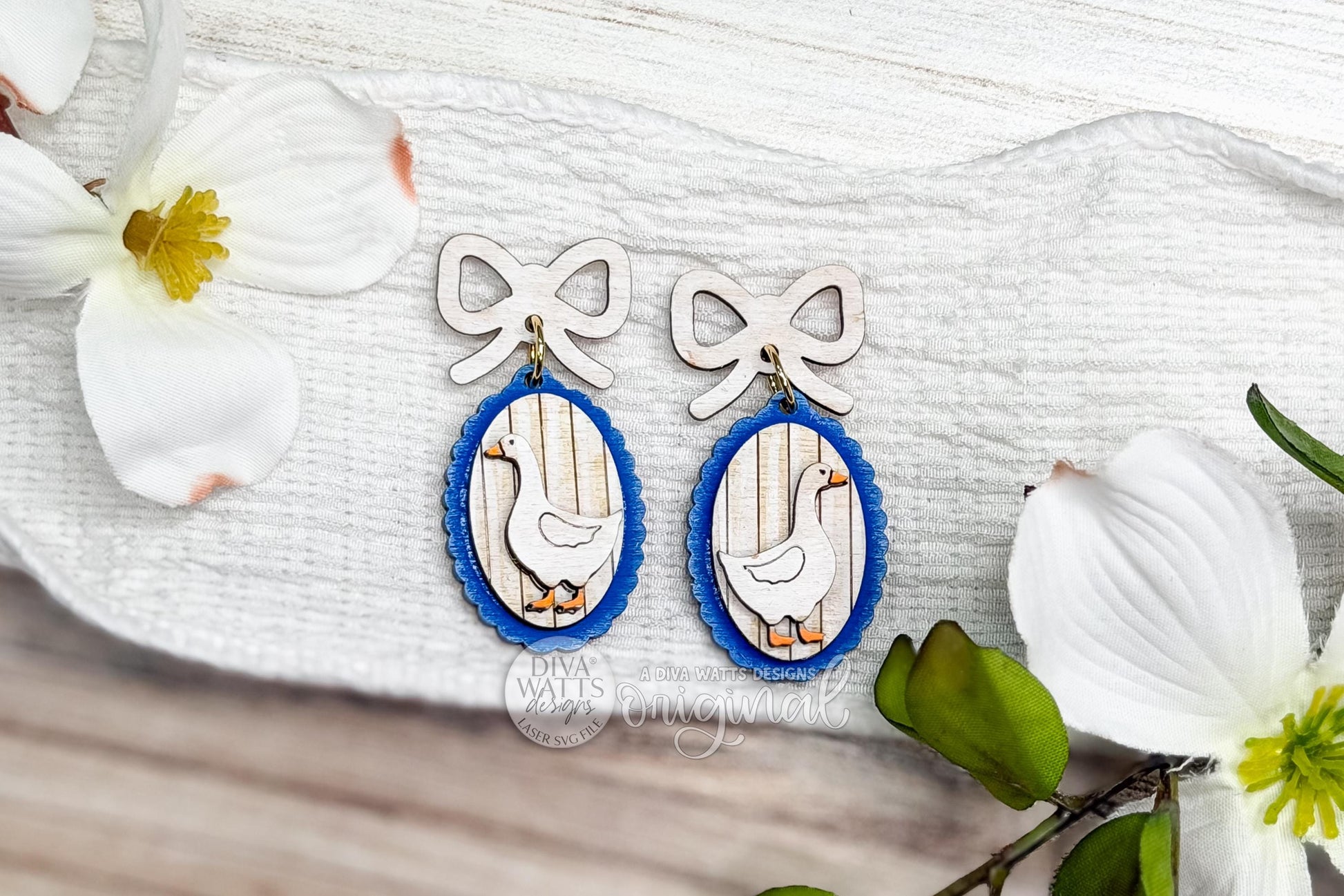 Digital SVG file for laser cut earrings featuring a cottagecore goose design with a bow topper and oval frame. This is a laser earring SVG only and an instant download, not a vinyl file. The digital design allows makers to create their own wood or acrylic earrings using a laser cutter. Ideal for cottagecore, grandma core, and coquette-style jewelry collections, spring accessories, and handmade gift earrings.