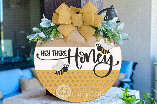 Digital SVG file for a round bee-themed door hanger with “Hey There Honey” text, designed for laser cutting and instant download. This laser cut design is shown as a finished porch sign example, but you receive a digital file only to create your own DIY round door hanger. Perfect for spring porch décor, summer signs, craft fair projects, and customizable laser cut door signs using Glowforge, xTool, or similar machines.